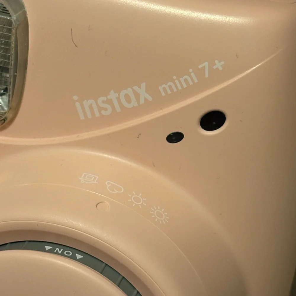 NWOT instax mini 7+ pink camera with a beaded lanyard (uses 4 AA batteries)